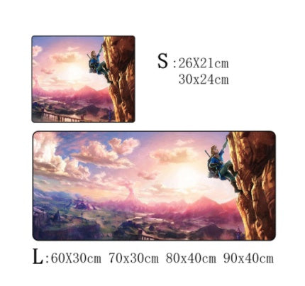 A gaming mouse pad featuring Link climbing a cliff with a sunset landscape.
