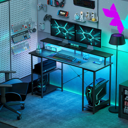 A distressed black computer desk with LED lights and storage, set up for gaming.