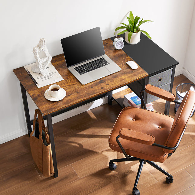 A rustic computer desk with a black side extension, a drawer, and a brown office chair.