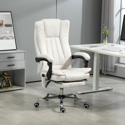 A white massage office chair with a footrest is positioned in a modern office setting.