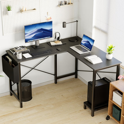 An L-shaped computer desk with a black top and metal frame, shown in a home office.