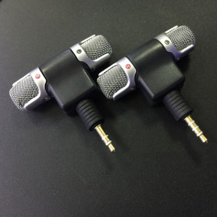 Two black and silver mini microphones with 3.5mm jacks are shown on a dark surface.