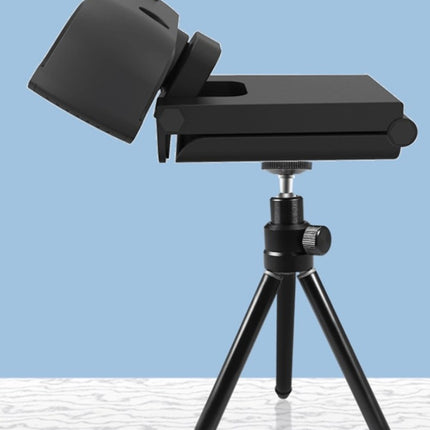 A black webcam with a built-in microphone is mounted on a small black tripod.