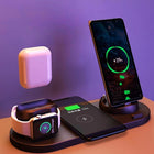A black 6-in-1 wireless charging dock powers a phone, smartwatch, and earbuds.